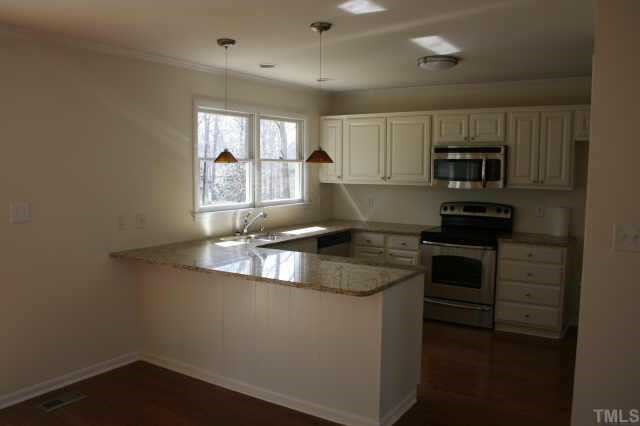 4204 Frost Court Raleigh, NC 27609 - Photo 3 of 6 View of new kitchen with stainless appliances and granite countertops.