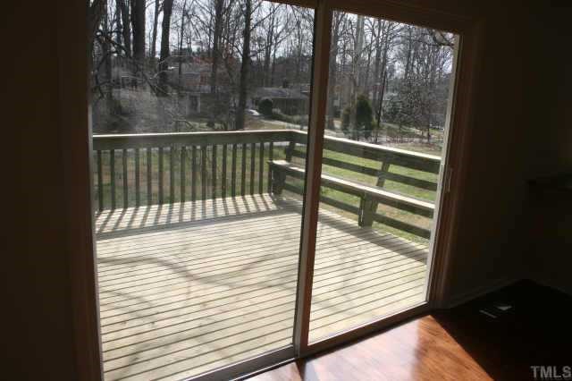 4204 Frost Court Raleigh, NC 27609 - Photo 5 of 6 View of deck through new sliding glass doors overlooking the rear, fenced in yard.