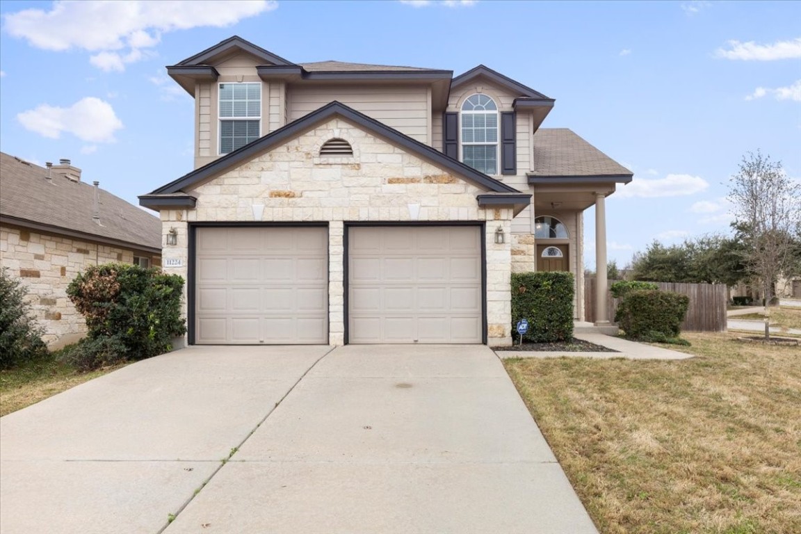11224 Mckinney Spring Drive Austin, TX 78717 - Photo 1 of 1 a front view of a house with a yard and potted plants