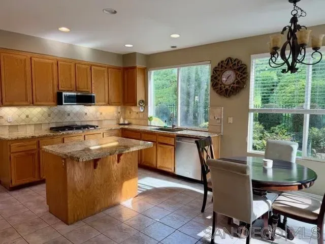 a kitchen with a stove a sink a counter top space and appliances