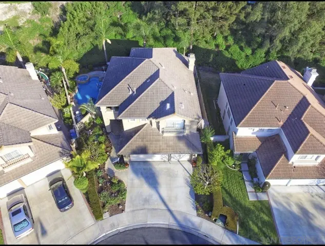 an aerial view of a house with a yard and garden