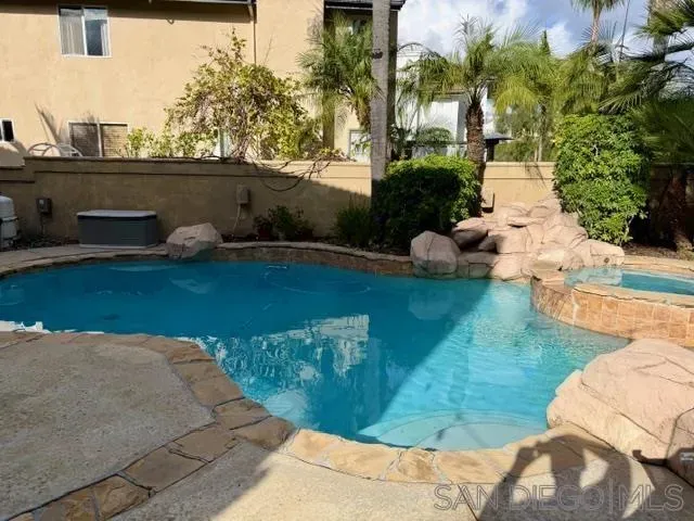 a view of a backyard with plants and outdoor seating