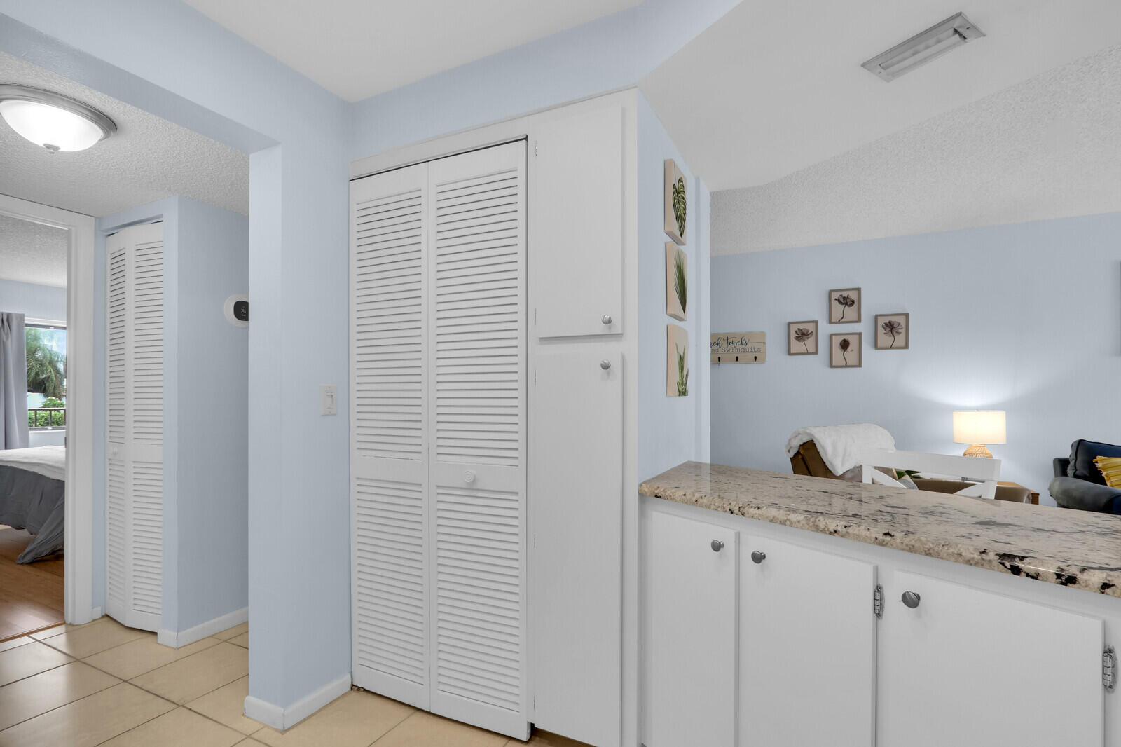 1605 Highway 1, Unit A204 Jupiter, FL 33477 - Photo 15 of 32 a bathroom with a granite countertop sink and a mirror