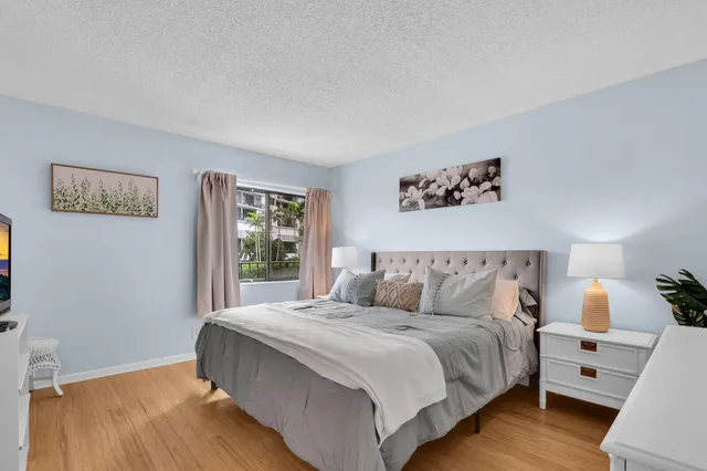 a bedroom with a large bed and a window