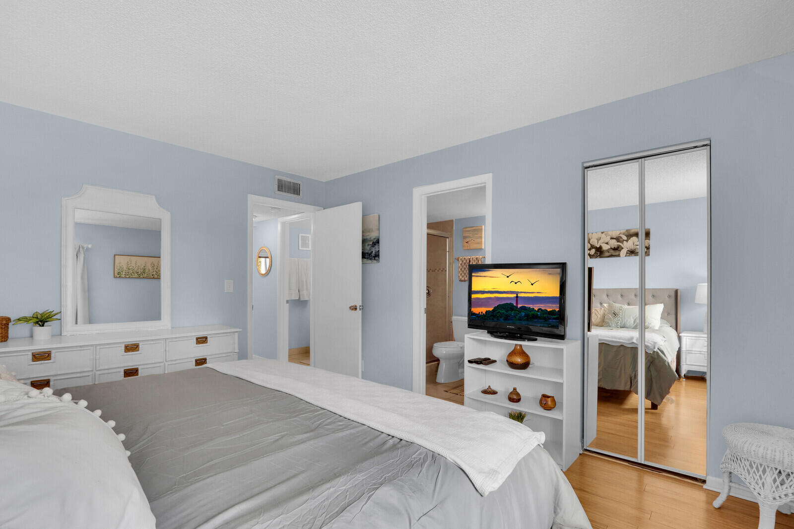 1605 Highway 1, Unit A204 Jupiter, FL 33477 - Photo 19 of 32 a bedroom with a bed and a flat screen tv