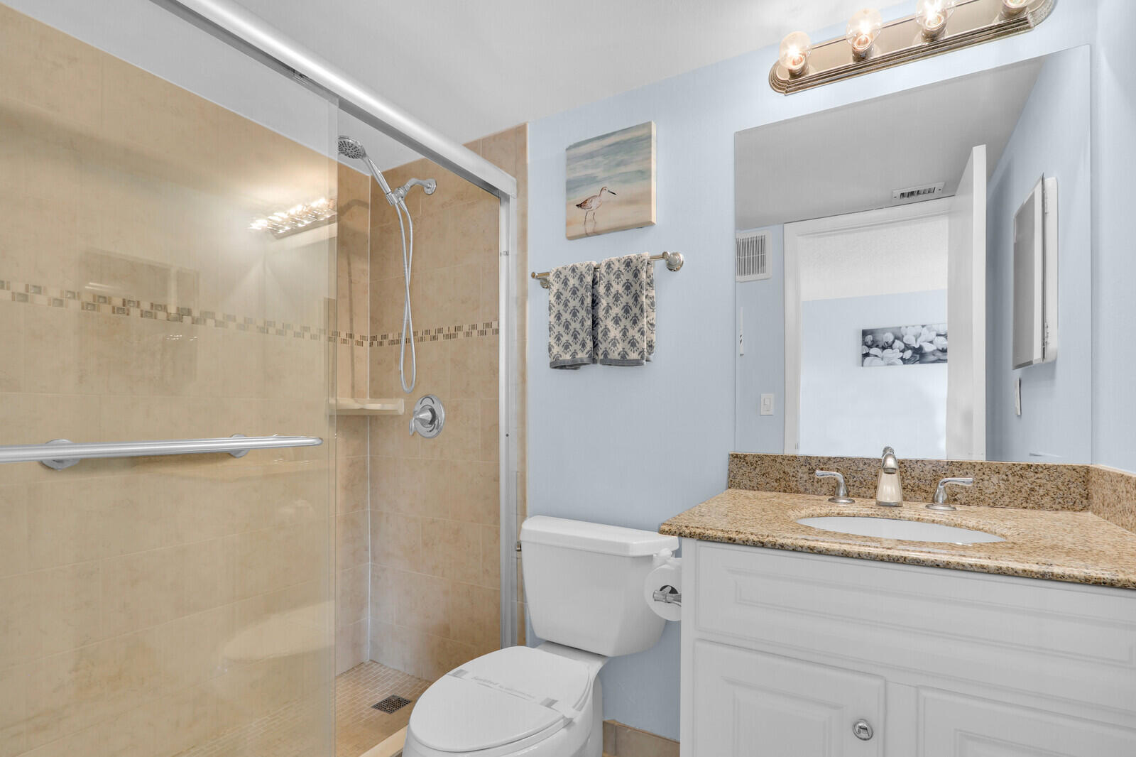 1605 Highway 1, Unit A204 Jupiter, FL 33477 - Photo 21 of 32 a bathroom with a granite countertop sink toilet and shower