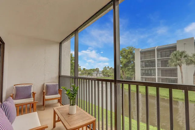 a view of a chair and table in the balcony