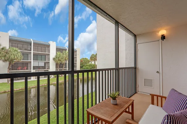 a balcony with table and chairs