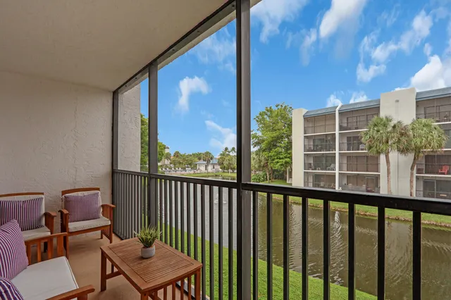 a view of a city from a balcony with furniture