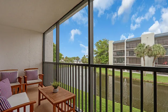 a view of a chair and table in the balcony