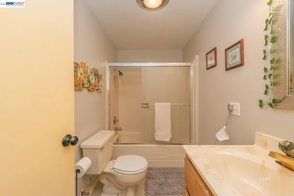 a kitchen with granite countertop a refrigerator a stove a microwave and cabinets