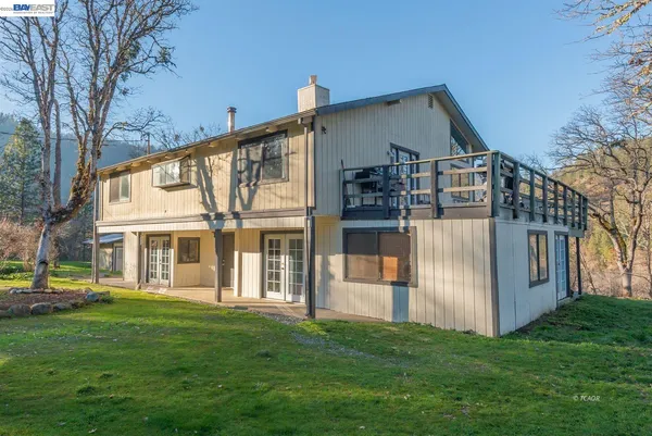 a view of balcony with wooden floor and fence