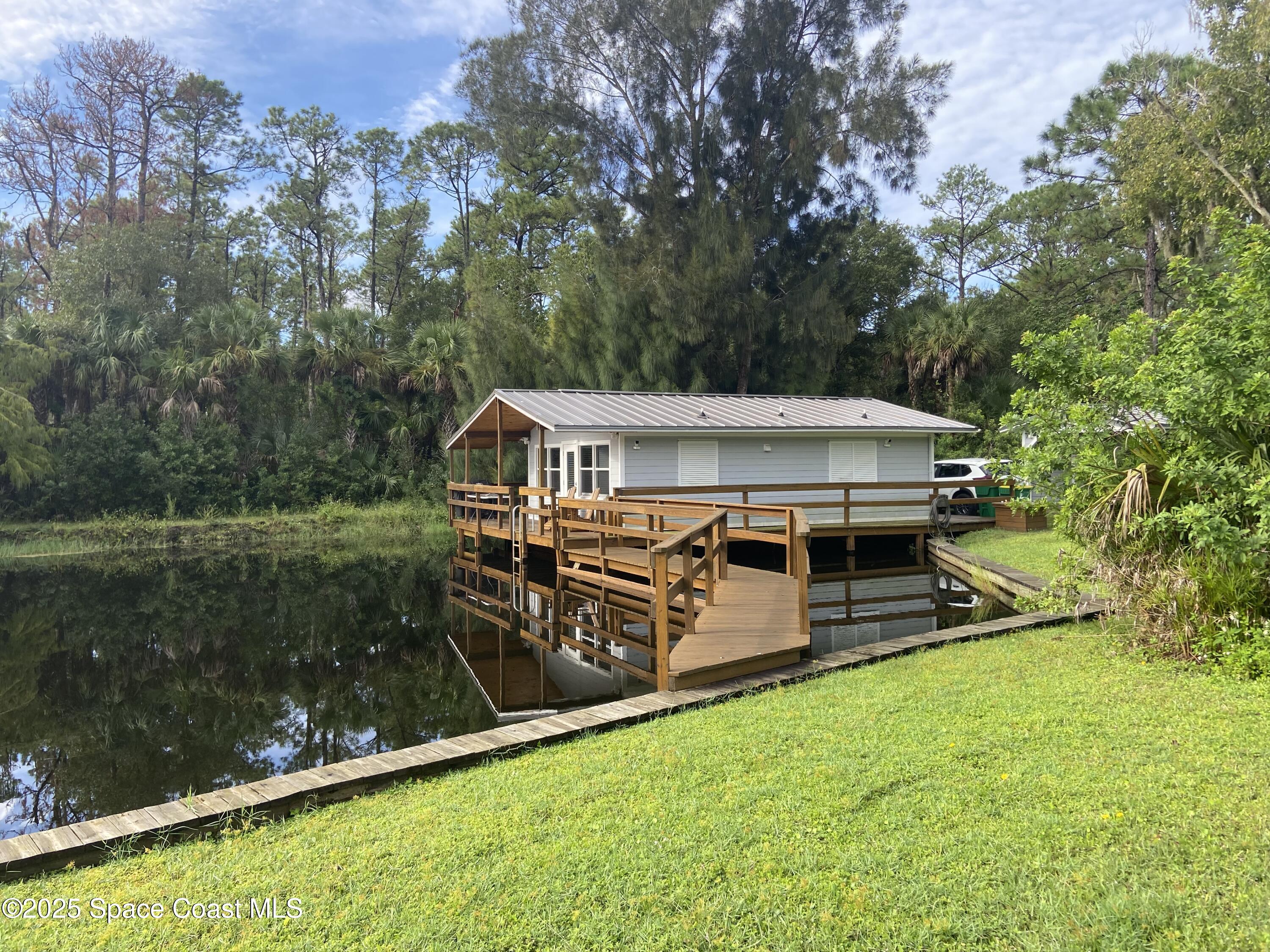 4655 Rector Road Cocoa, FL 32926 - Photo 11 of 47 an aerial view of a house with swimming pool a yard and a fountain
