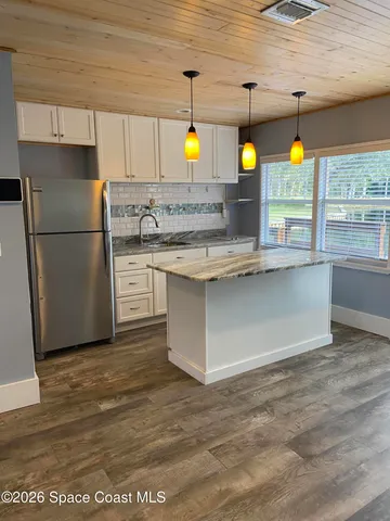 a kitchen with a sink and refrigerator