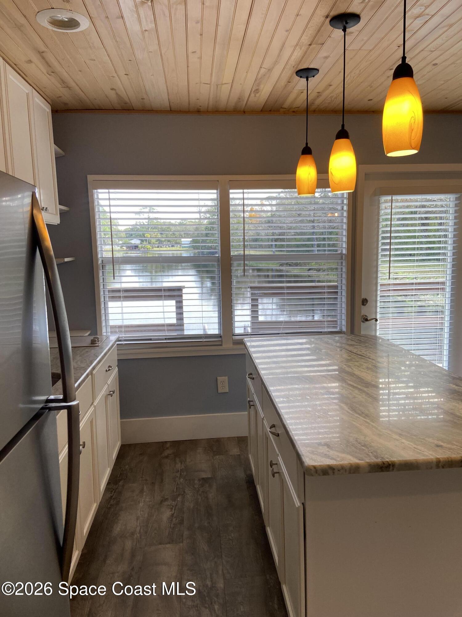 4655 Rector Road Cocoa, FL 32926 - Photo 17 of 47 a kitchen with stainless steel appliances granite countertop a sink a stove and a wooden floors