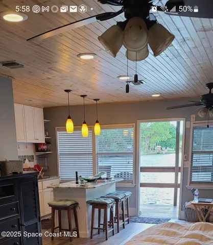 a kitchen with a table chairs and a wooden floor
