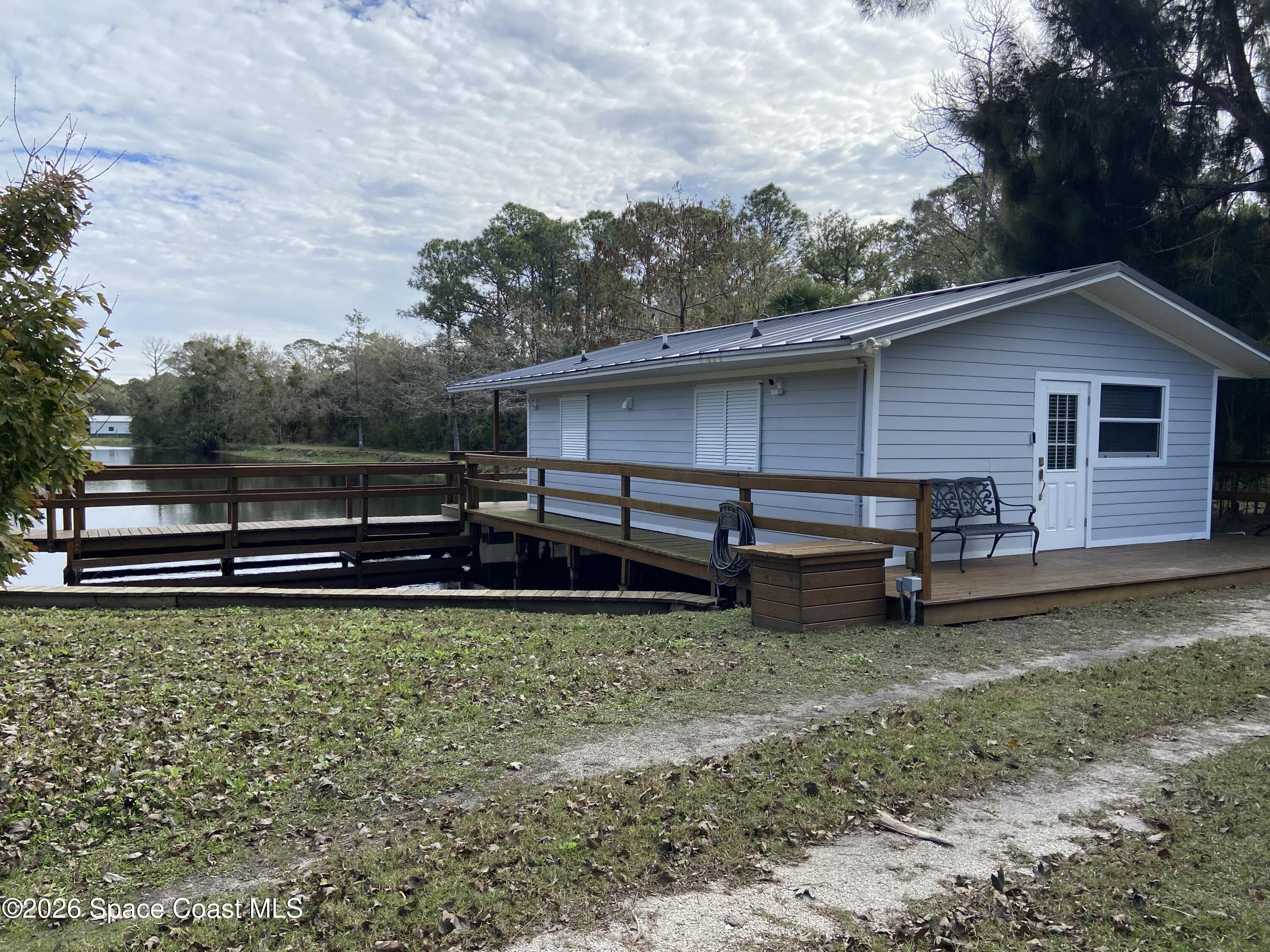 4655 Rector Road Cocoa, FL 32926 - Photo 27 of 45 a view of a backyard with a small cabin