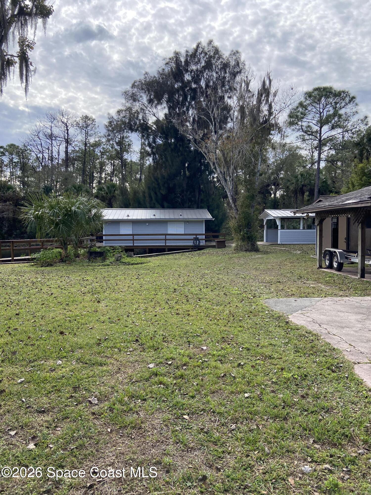 4655 Rector Road Cocoa, FL 32926 - Photo 31 of 45 a view of a house with yard and sitting area
