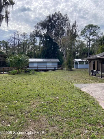 a view of a house with yard and sitting area
