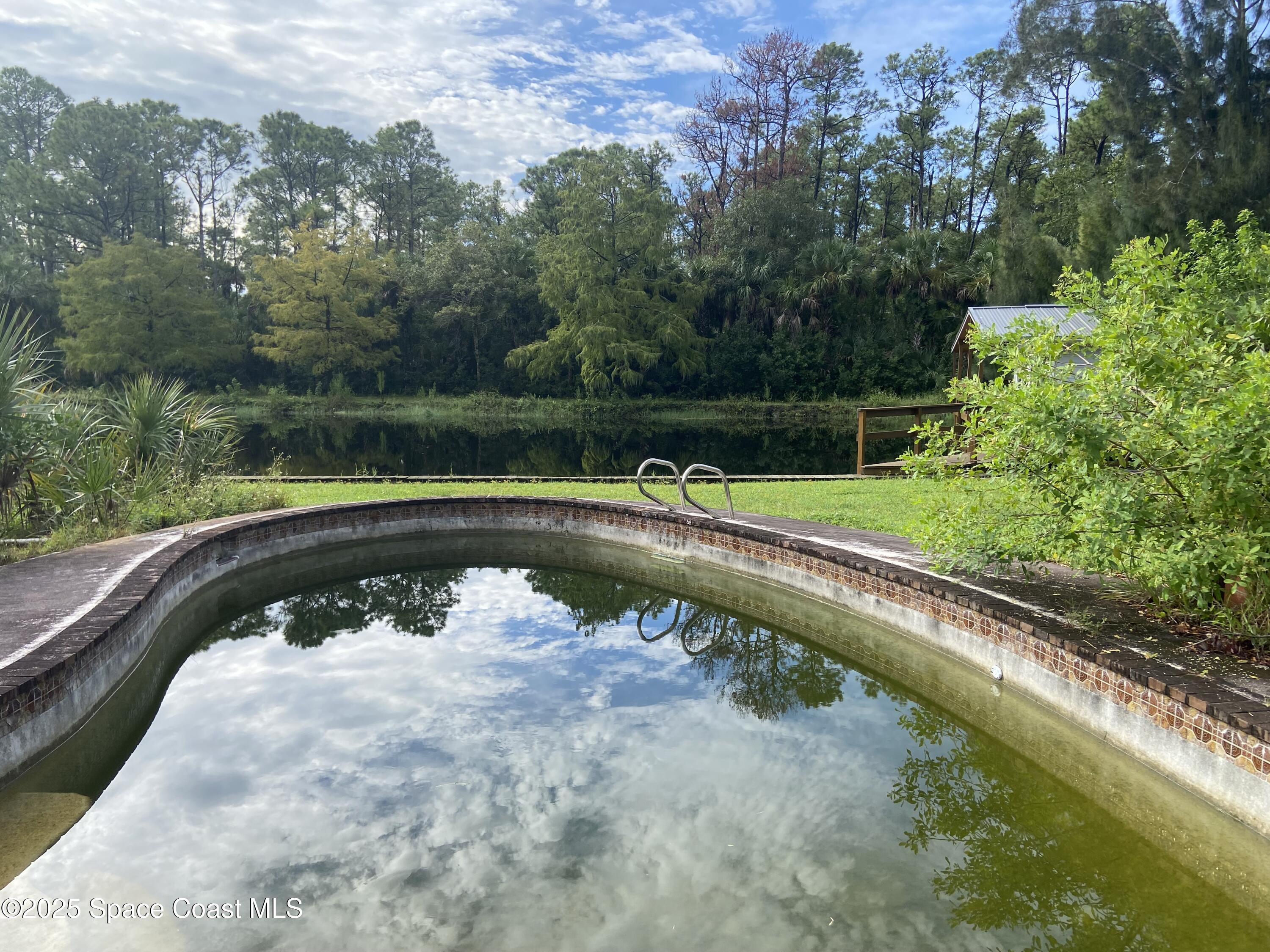 4655 Rector Road Cocoa, FL 32926 - Photo 6 of 47 a view of a swimming pool with a lake view