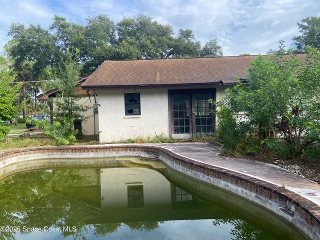 a house with swimming pool in front of it