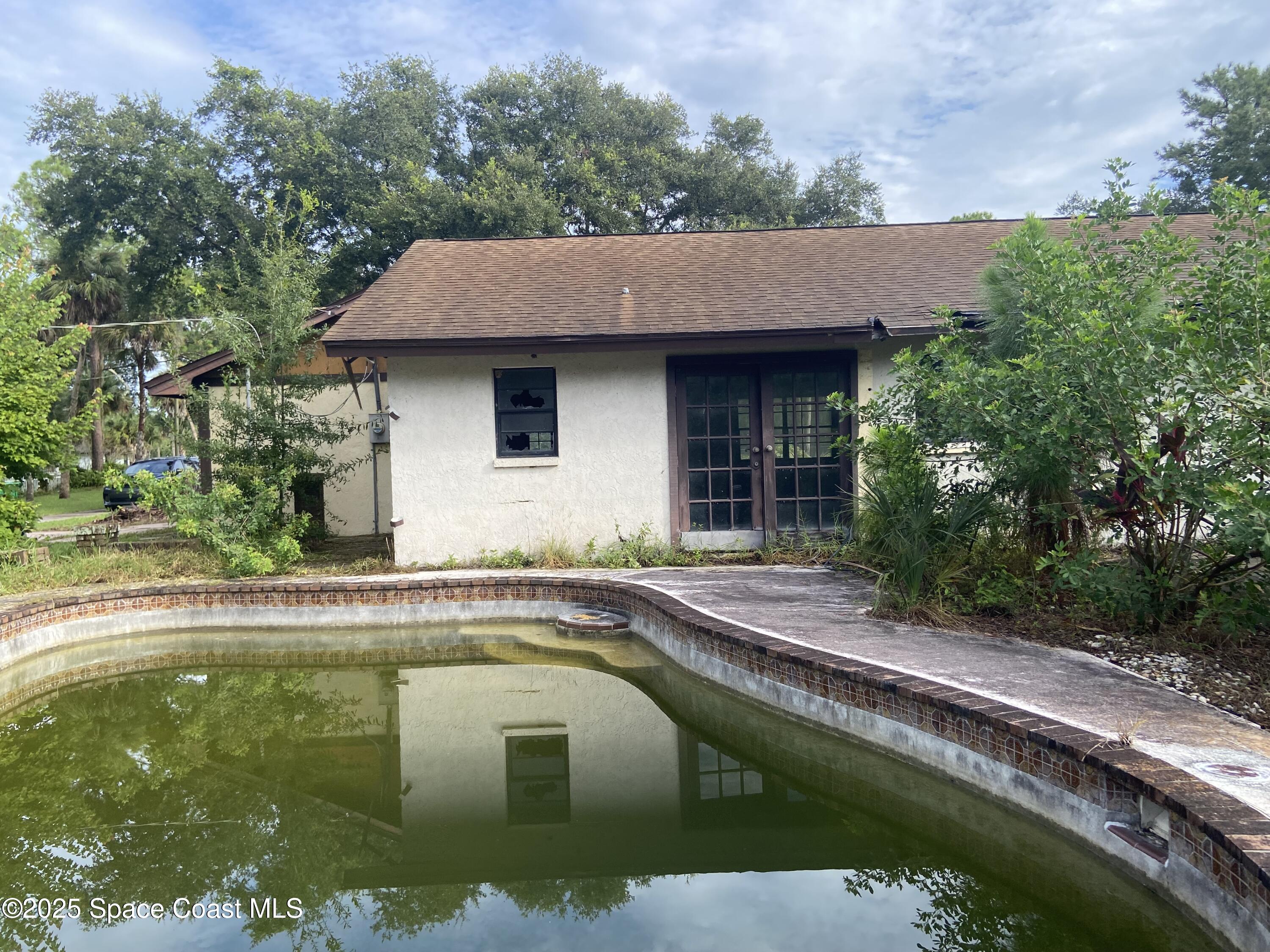 4655 Rector Road Cocoa, FL 32926 - Photo 7 of 47 a house with swimming pool in front of it
