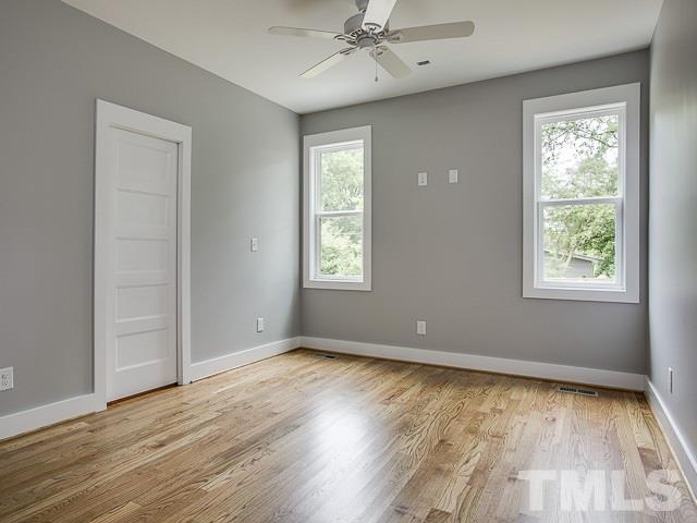 1002 Caspan Street Raleigh, NC 27610 - Photo 12 of 25 a view of an empty room with wooden floor and a window