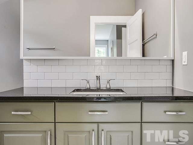 1002 Caspan Street Raleigh, NC 27610 - Photo 13 of 25 a kitchen with a sink and cabinets