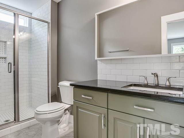 1002 Caspan Street Raleigh, NC 27610 - Photo 14 of 25 a bathroom with a granite countertop sink toilet and shower