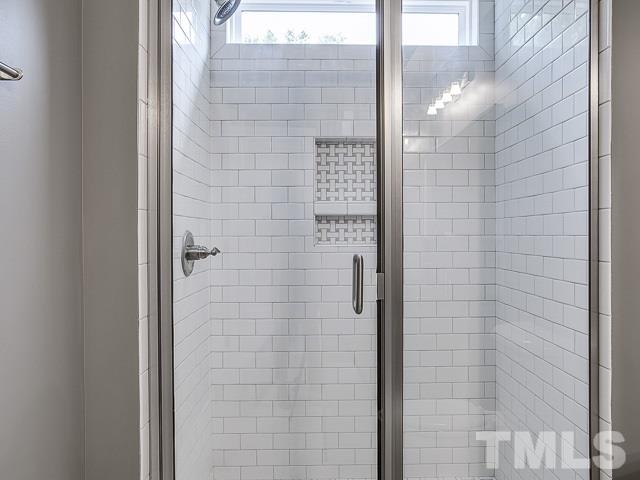 1002 Caspan Street Raleigh, NC 27610 - Photo 16 of 25 a bathroom with a shower