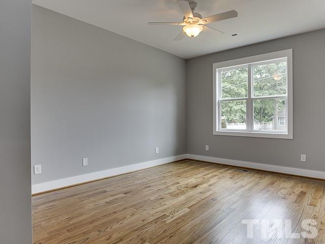 1002 Caspan Street Raleigh, NC 27610 - Photo 17 of 25 a view of an empty room with wooden floor and a window