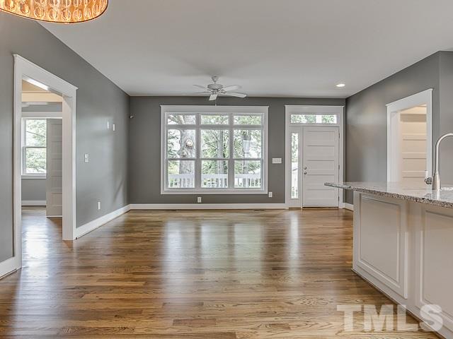 1002 Caspan Street Raleigh, NC 27610 - Photo 3 of 25 a view of an empty room with window and wooden floor