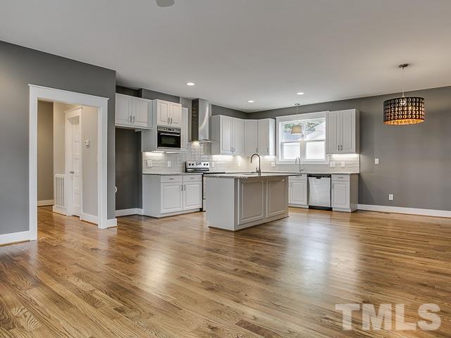 1002 Caspan Street Raleigh, NC 27610 - Photo 4 of 25 a view of kitchen with cabinets microwave and stove