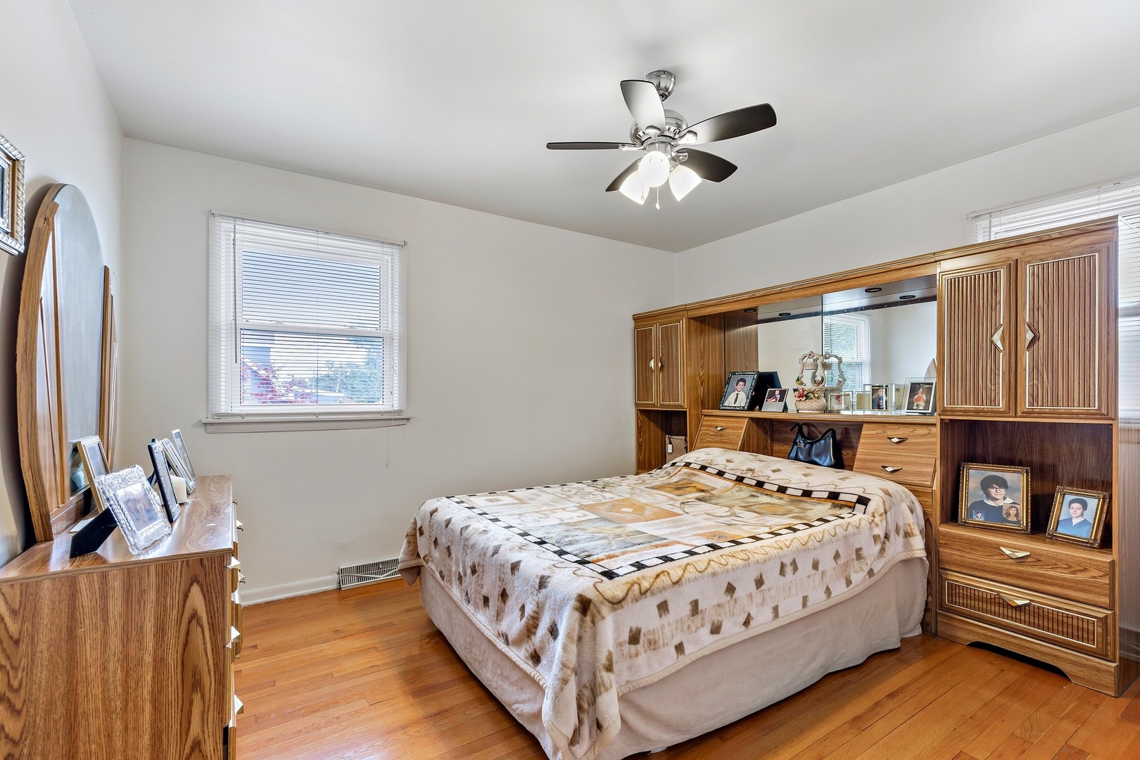 216 West Plainfield Road Countryside, IL 60525 - Photo 11 of 20 a bedroom with a bed chandelier and a window