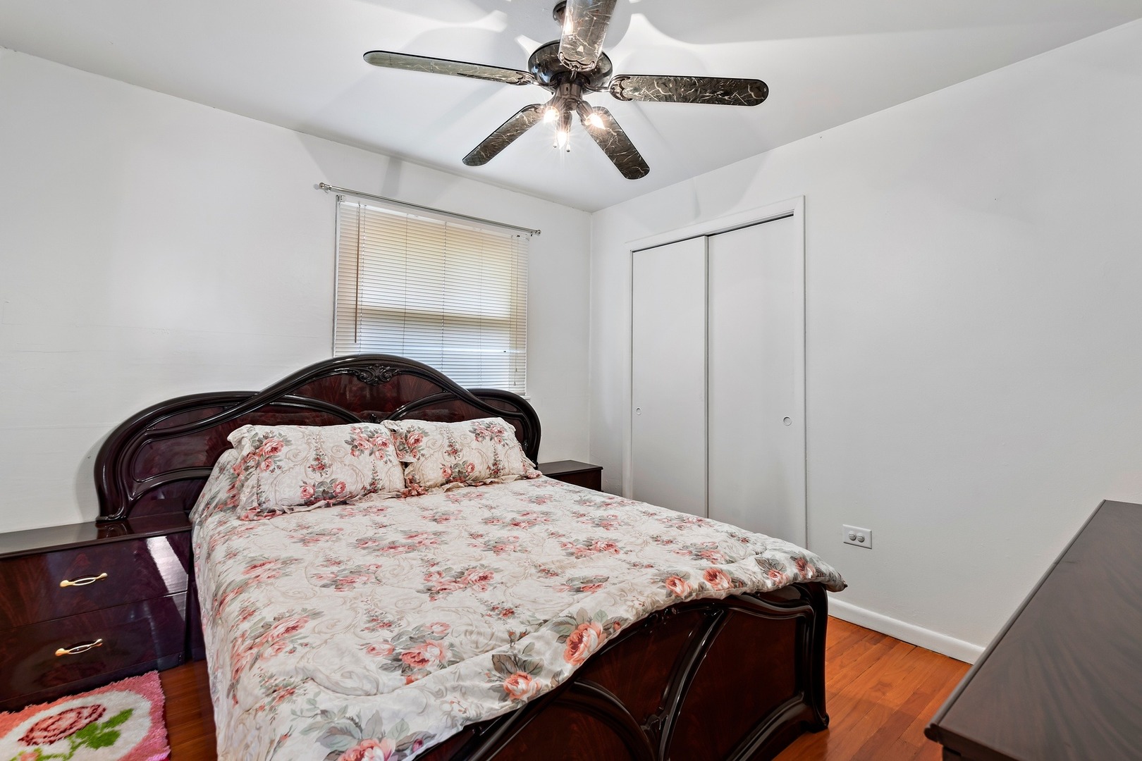 216 West Plainfield Road Countryside, IL 60525 - Photo 12 of 20 a bedroom with a bed and a chandelier