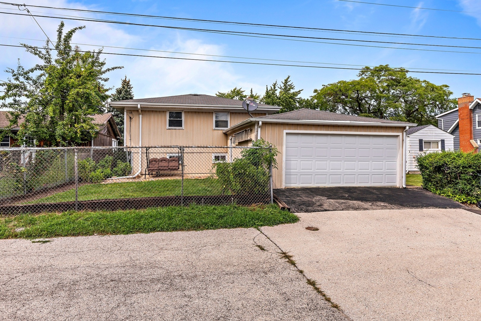 216 West Plainfield Road Countryside, IL 60525 - Photo 20 of 20 a front view of a house with a yard and a garage
