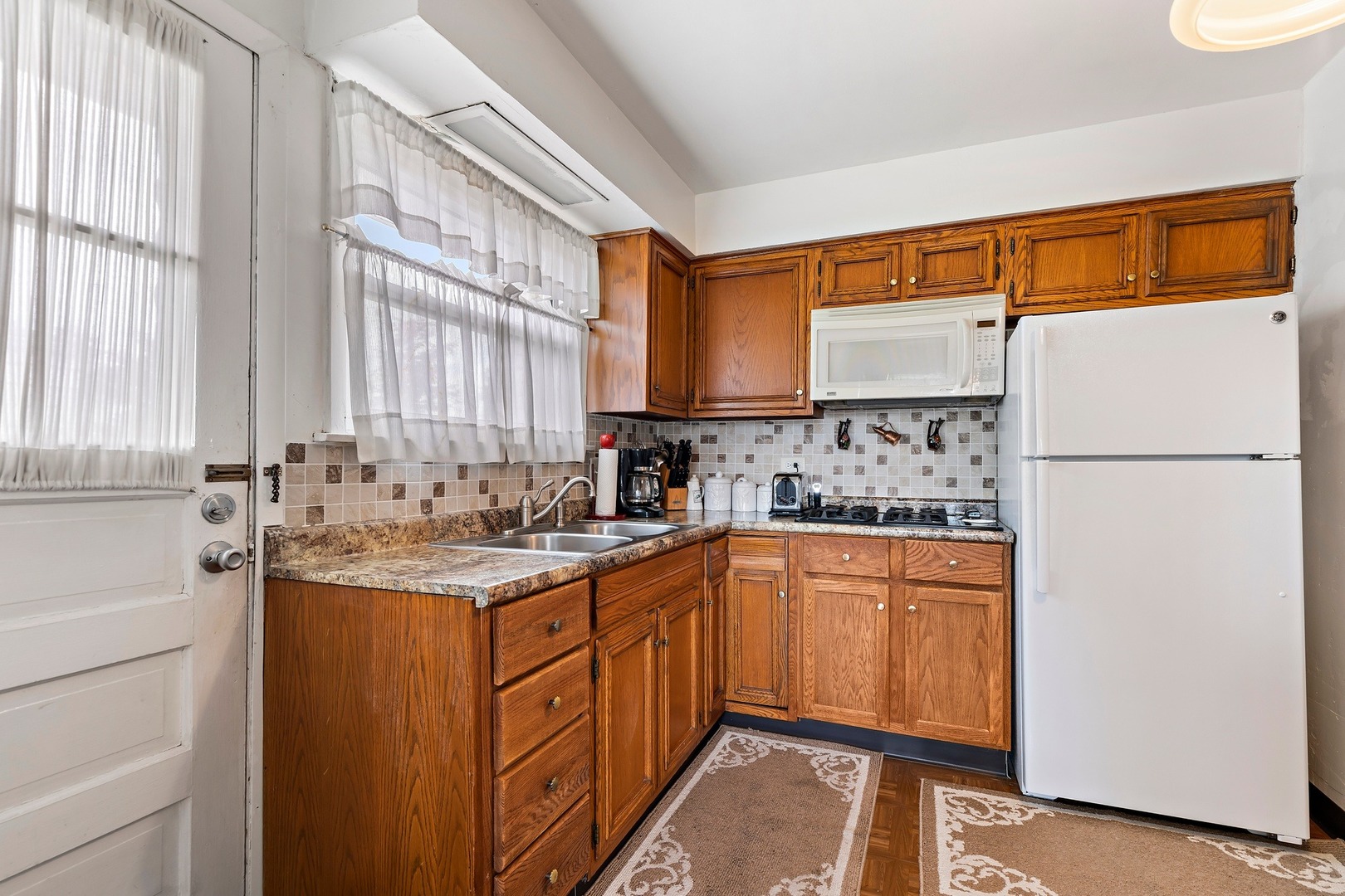 216 West Plainfield Road Countryside, IL 60525 - Photo 10 of 20 a kitchen with stainless steel appliances granite countertop a sink and a refrigerator