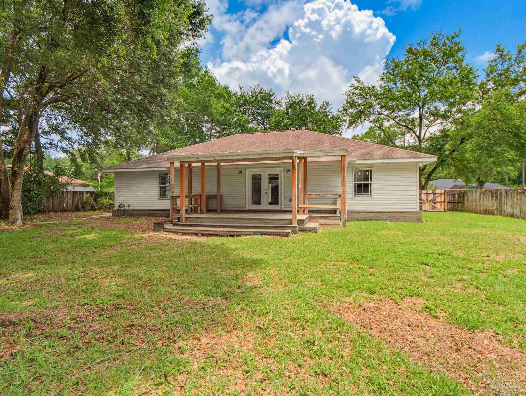 5567 Jones Street Milton, FL 32570 - Photo 45 of 48 a front view of house with yard and trees