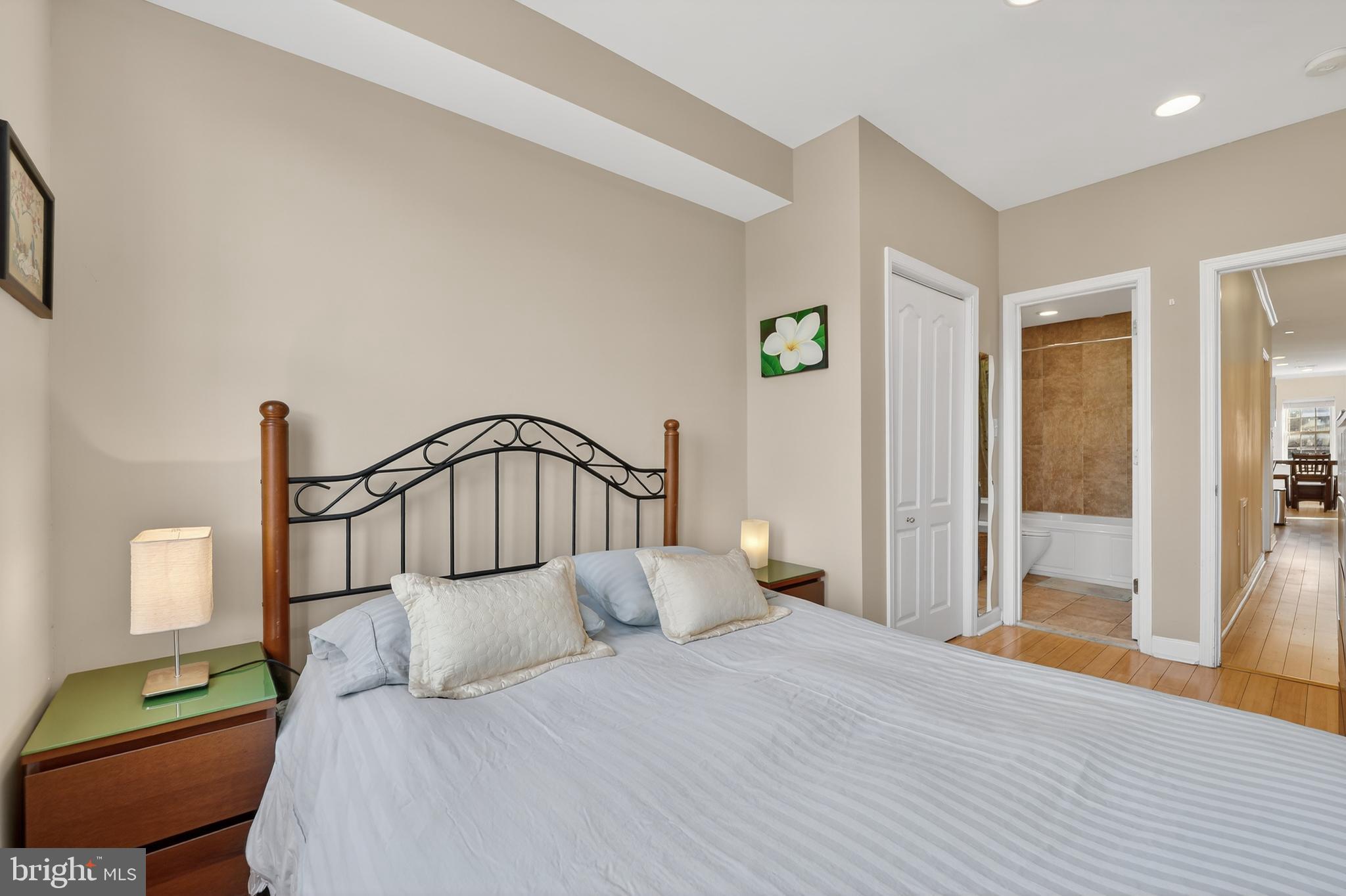 1337 Harvard Street Northwest, Unit 2 Washington, DC 20009 - Photo 10 of 23 a bedroom with a bed and a mirror