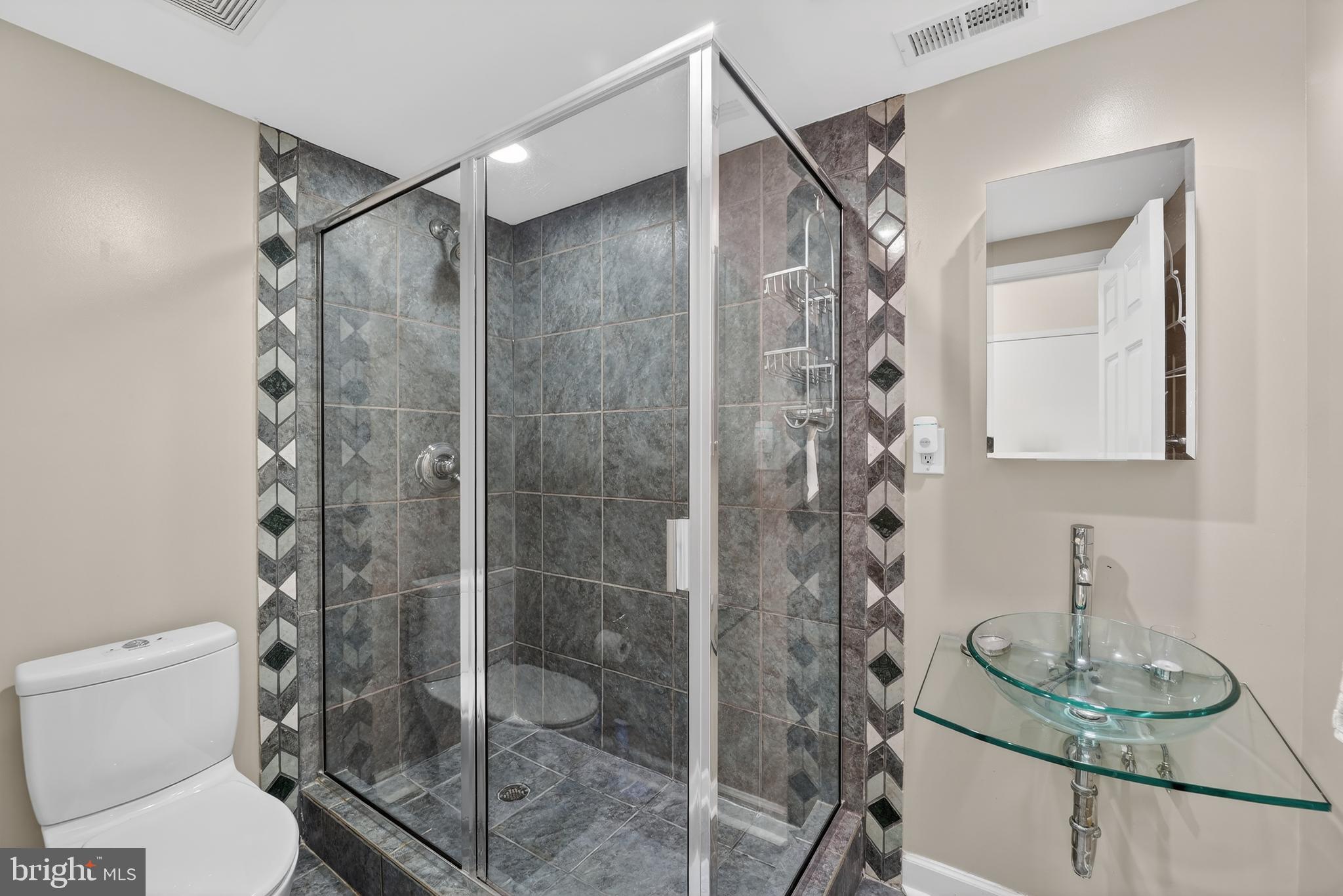 1337 Harvard Street Northwest, Unit 2 Washington, DC 20009 - Photo 14 of 23 a bathroom with a shower a toilet and a sink
