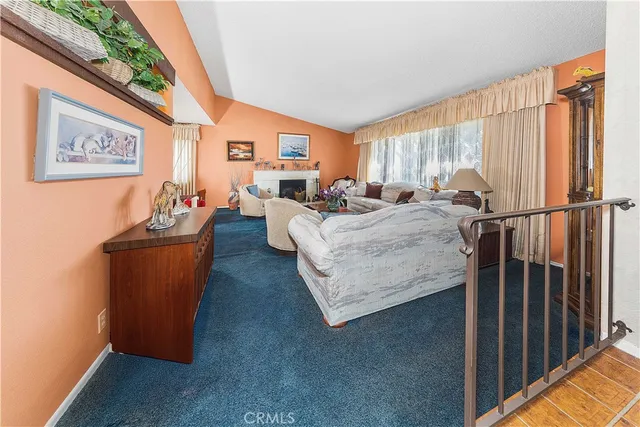 a living room with furniture fireplace and window