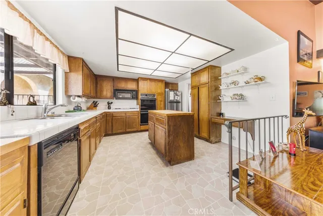 a kitchen with sink cabinets and appliances