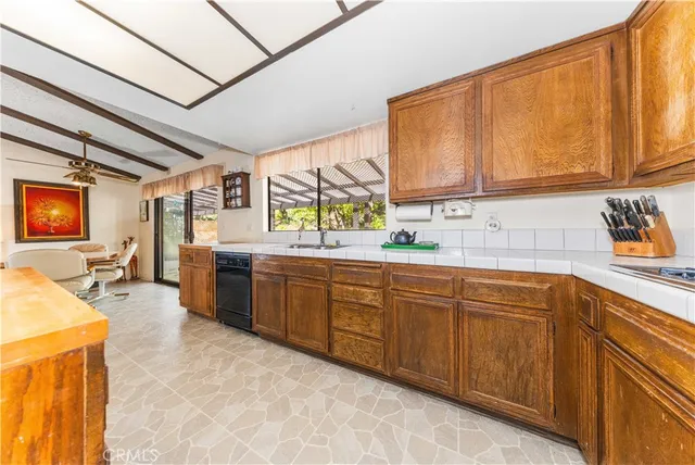 a large white kitchen with a large window