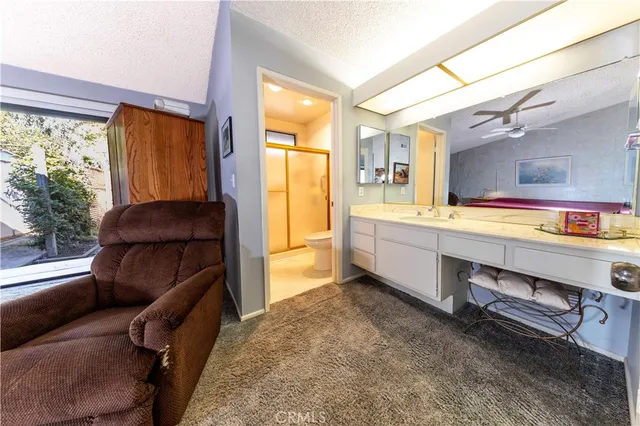 a living room with lots of furniture and a book shelf