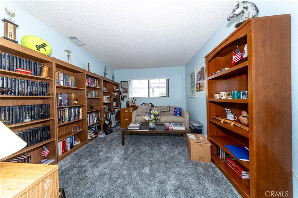 4275 Thomas Court Simi Valley, CA 93063 - Photo 37 of 59 a living room with lots of furniture and a book shelf