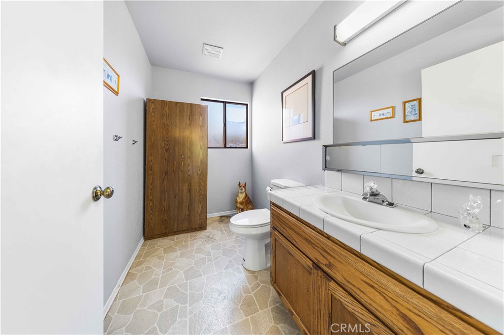 4275 Thomas Court Simi Valley, CA 93063 - Photo 56 of 59 a bathroom with a granite countertop sink a toilet and shower