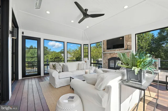 a kitchen with stainless steel appliances granite countertop a stove a refrigerator a kitchen island a sink dishwasher a dining table and chairs with wooden floor