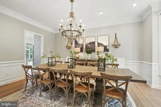 a view of a hallway with wooden floor and windows