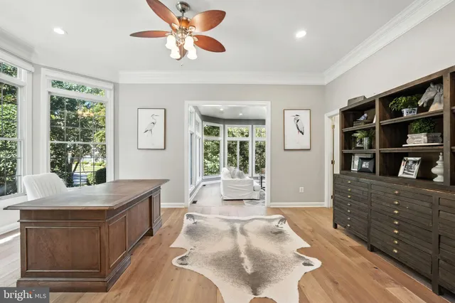 a spacious bedroom with a bed and a flat tv screen on dresser