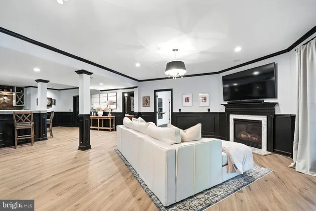 a view of a hallway with wooden floor and windows